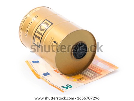 a barrel of crude oil lies on a pile of paper Euro bills