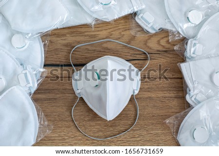 A lot of medical face dust masks, disposable FFP3 respirators protective mouth filter mask. Concept of coronavirus, sars, air pollution, virus, flu, infectious diseases and precautions. A stock masks. Royalty-Free Stock Photo #1656731659
