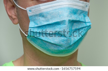 Blue Medical Disposable Face Mask incorrectly put,Coronavirus mask ,disease (COVID-19),protective mask- Royalty-Free Stock Photo #1656757594