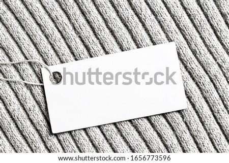 White label on a woolen fabric. Abstract background for design. Art stylized baner or mock up with copy space for a text.