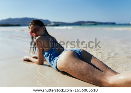 young woman in a beautiful swimsuit on the beach