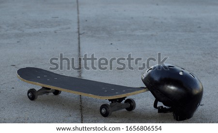 A skateboard and helmet on concrete