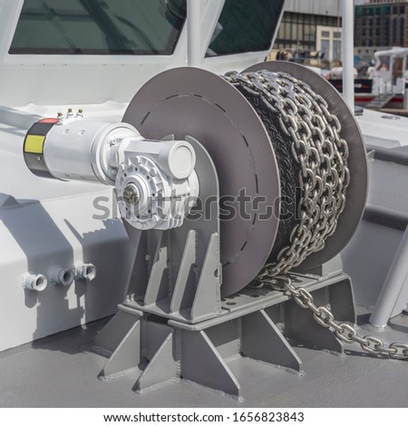 powerful anchor winch on the deck of a military boat