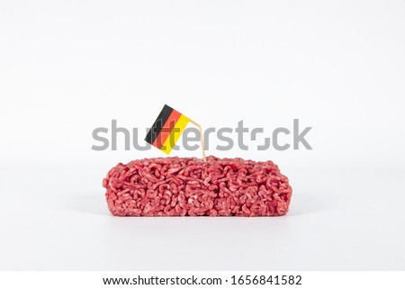 Broken german flag on a toothpick is sticking in high quality german beef minced meat