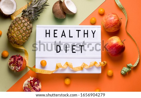 lightbox on a green and orange background with the words healthy diet next to different fruits