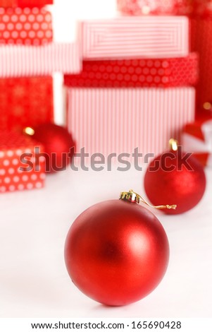 Christmas background with a red ornament, red gift boxes, red christmas balls 