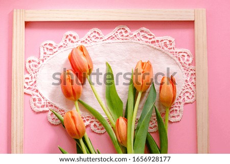 Tulips on pink background  with a frame for an advertisement. Woman's day present.