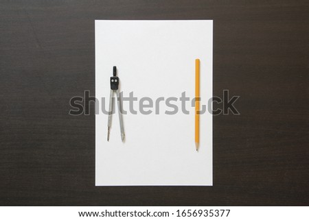 Template of white paper, divider and pencil on dark wenge color wooden background. Concept of new idea, business plan and strategy. Stock photo with empty space for text and design