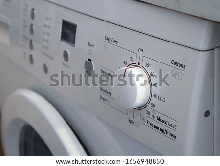 white goods washing machine controls in white stock photo