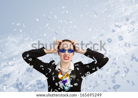 Image of irritated businesswoman in goggles with business collage at background