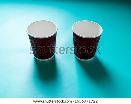 Eco-friendly degradable disposable cups on a blue background