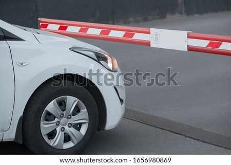 White car in front of the barrier. Detail close-up.