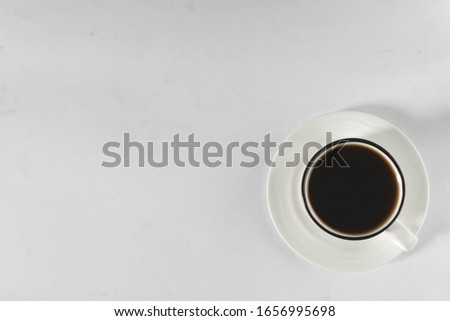 Top view of Coffee in a white mug with a black rim