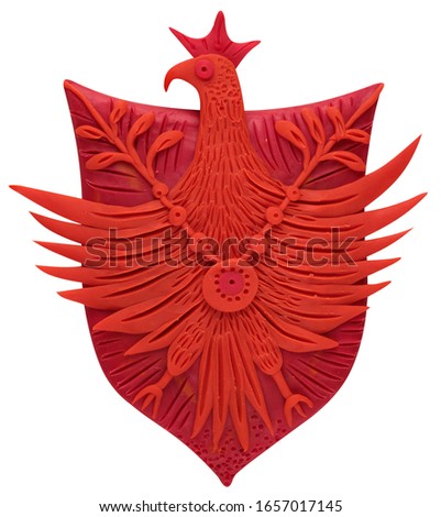 
abstract red coat of arms, in the form of a bird on a shield, protects, molded from plasticine