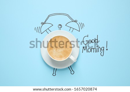 Composition with Good Morning wish and aromatic coffee on light blue background, top view Royalty-Free Stock Photo #1657020874