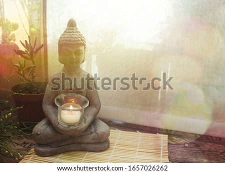 Buddha statue on the floor on a sunny morning. Home decoration for relaxation