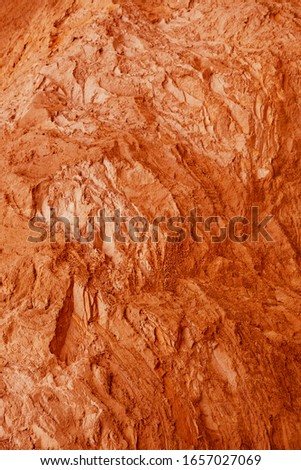Natural blurred background, selective focus.The structure of different layers of earth in a clay quarry after geological study of the soil.