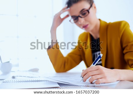 Business woman with desktop reading document at her office