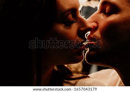 A young couple kisses in the evening. Romantic date. Love story.