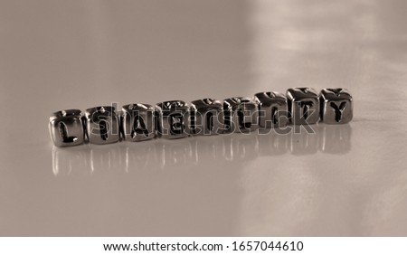 Liability - word from metal blocks on  - concept sepia tone photo on shine background
