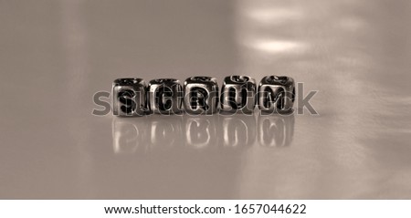Scrum -  word from metal blocks - concept sepia tone photo on shine background
