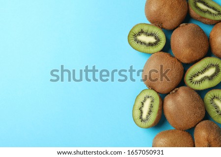 Ripe sweet kiwi on blue background, top view