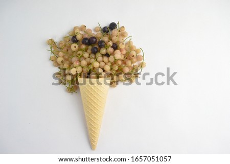 Frozen currants in waffle cone isolated on white background.