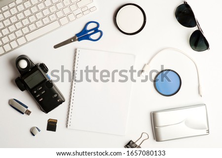 Flat assembly composition with photographic production equipment on plain white background, top view