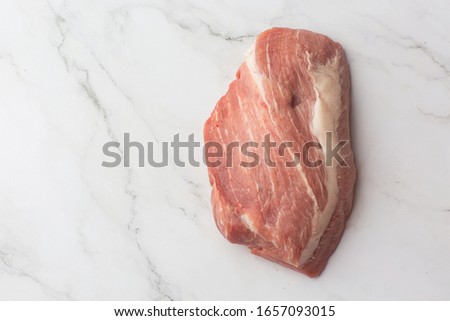 Meat, pork, slices pork loin on a white background. Raw pork meat. Advertising for meat shop and farm. Various kinds of meat and ready to cook concept. Top view. Space for text