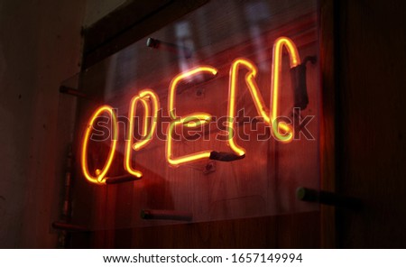 Open. Neon sign on the door. invitation to a night club.