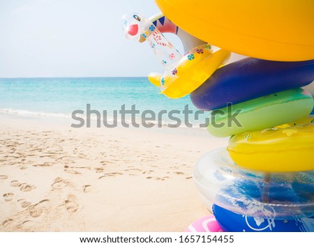 Close up floating ring on beach with blur image of blue sea. Summer and holiday concept.