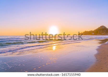 Beautiful tropical nature beach sea ocean with sunset or sunrise for travel vacation