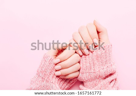 Woman's hands with beautiful manicure on pink background. Hands spa concept Royalty-Free Stock Photo #1657161772