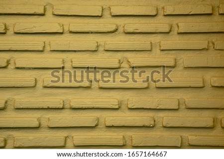 Light yellow brick wall,Brick wall painted yellow texture.