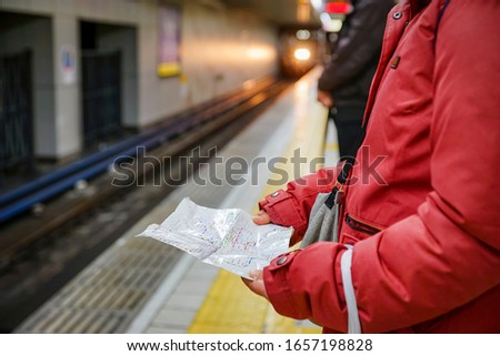 Asian woman in Japan train station use  railway map in Japan travel
