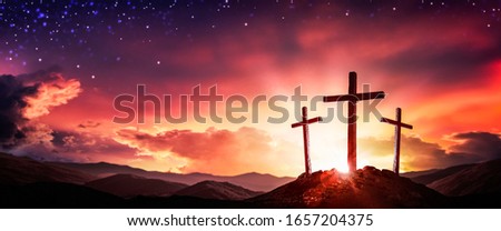 Three Wooden Crosses At Sunrise With Clouds And Starry Sky Background