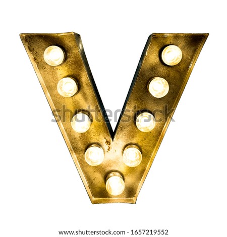 Letter V made of golden metal illuminated with light bulbs