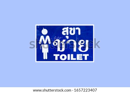 Toilet signs for man or toilets. Written in Thai and English alphabet. Blue background. selective focus 
