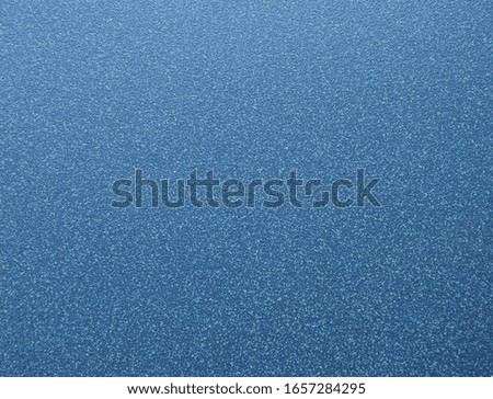 Polished surface of natural blue granite with white specks of a fine fraction. Background, texture.
