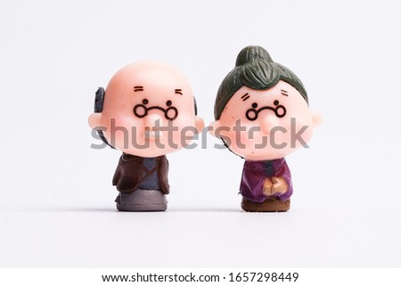 Old man and lady miniature on white background.