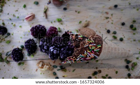 Variety of ice cream scoops in cones with chocolate, vanilla and strawberry