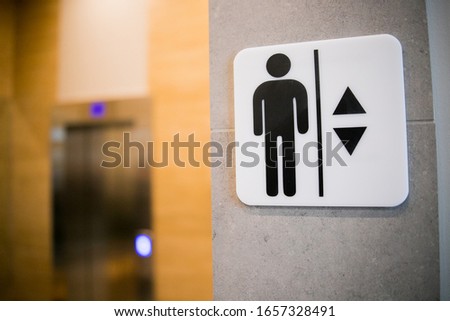 Lift or elevator symbol on concrete wall background