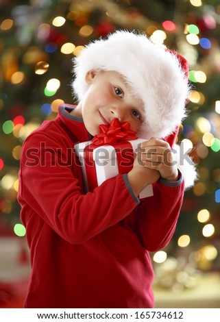 happy little boy holding Christmas gift