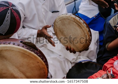 
Playing tambourines when traditional shows become commonplace. Tambourine is a round and flat drum which is a typical Malay tribe. Royalty-Free Stock Photo #1657347508