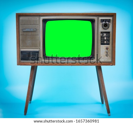 Vintage Retro Style old television with cut out screen, old television on blue background. Television with green screen.