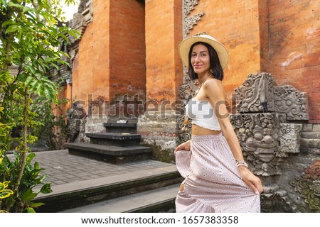 Merry young lady is visiting exotic religion centres abroad and enjoying ancient architecture. Website banner