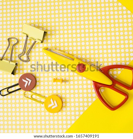 School supplies. Empty Notepad. Yellow and red colors. Flat lay composition. Yellow background. Back to school. Square photo size.