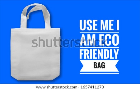 Use Me I am Eco friendly bag. Non woven fabric white bag on blue background.
