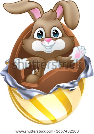The Easter bunny rabbit breaking out of a chocolate egg