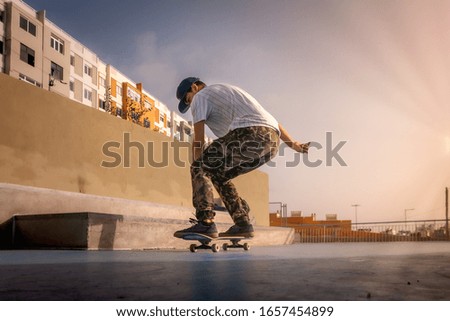 photo 4 (landing). Young skater does a trick called boneless. skateboarding
